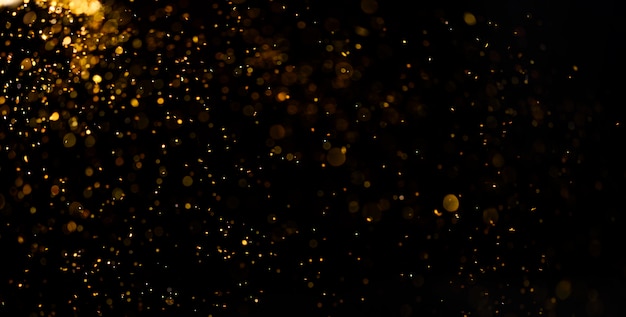 Premium Photo | Abstract golden dust on black surface