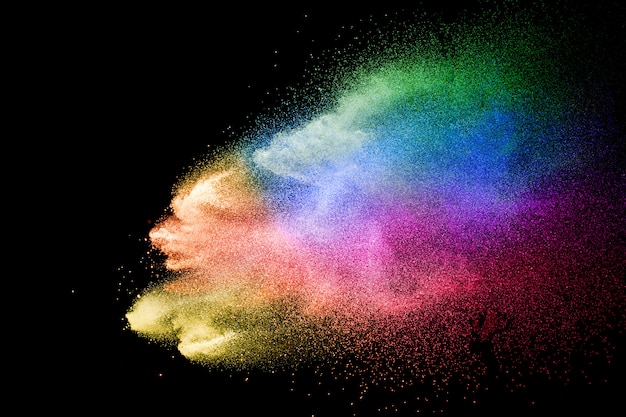 Abstract multicolored powder explosion on black background. color dust particle splattered Premium Photo