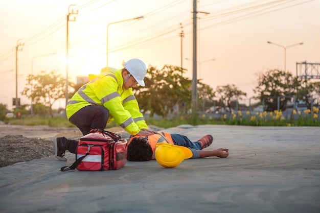 Accident at work of construction labor people, basic first aid and cpr training at outdoor. Premium 