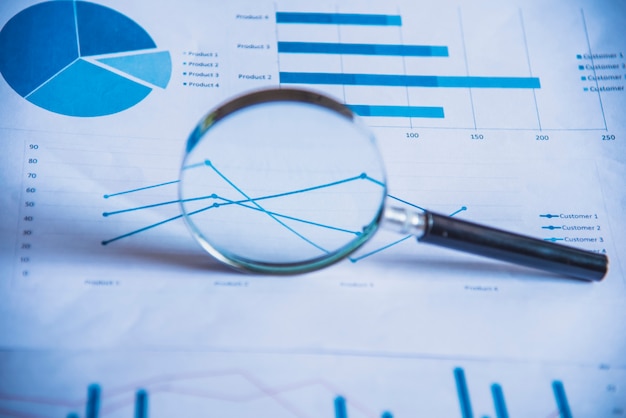 Accounting data, charts and magnifying glass. Many charts and graphs ...