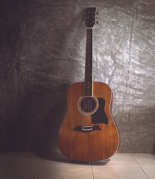 Premium Photo | Acoustic guitar on dark wall in vintage tone