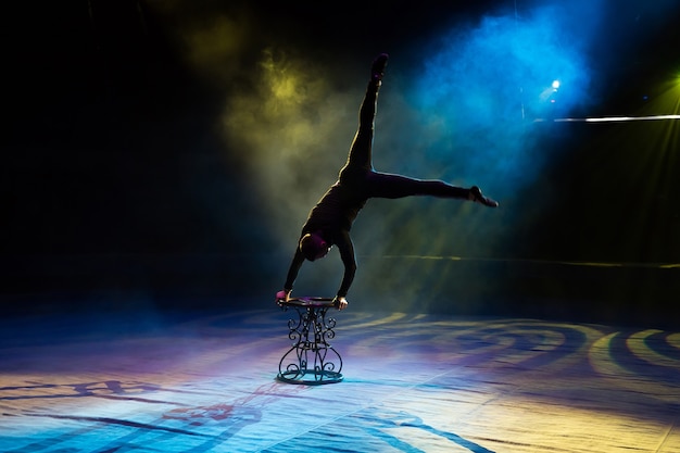 Premium Photo | Acrobat performs a difficult trick in the circus.