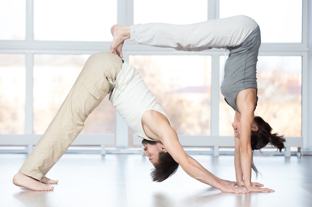 Free Photo | Acroyoga, adho mukha svanasana