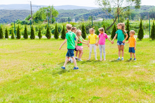 Premium Photo | Active children play together outdoor games during the ...