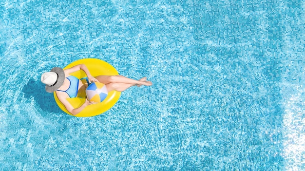 Premium Photo | Active young girl in swimming pool aerial top view from ...