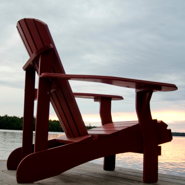 Adirondack chair on a pier at the lakeside, lake of the ...