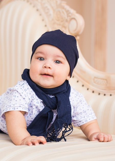 Premium Photo | Adorable baby boy in white sunny bedroom. newborn child ...