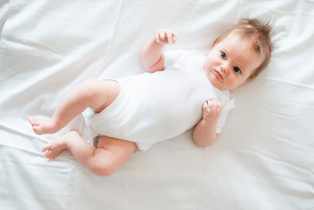 Adorable Baby Laying On Bed Photo Free Download