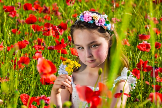 Premium Photo | Adorable child in flower field in summer