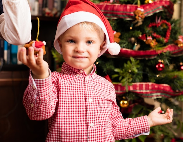 Free Photo | Adorable child holding a christmas ornament