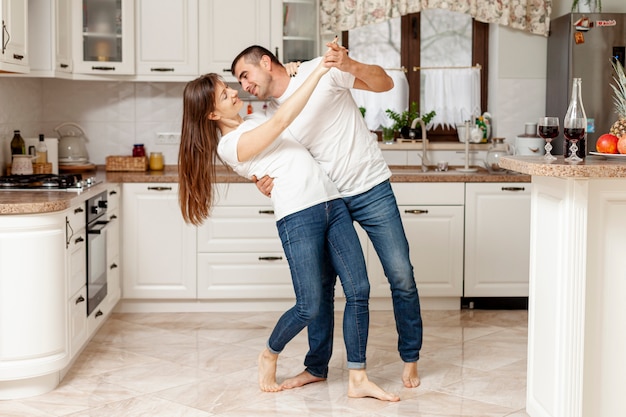 Adorable Couple Dancing In Kitchen Photo Free Download 