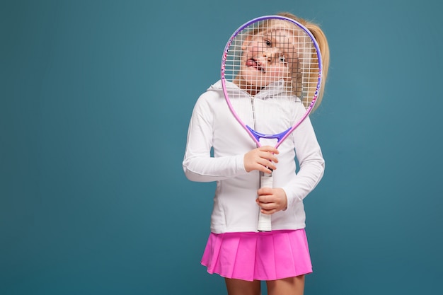 Adorable cute little girl in white shirt, white jacket and pink skirt with tennis racket Premium Photo