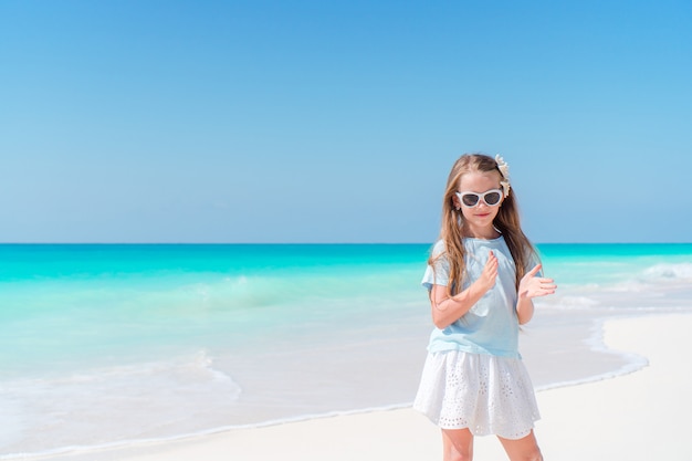 Premium Photo | Adorable little girl have fun at tropical beach during ...