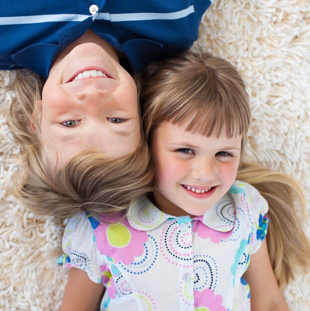 Premium Photo Adorable Siblings Lying On The Floor