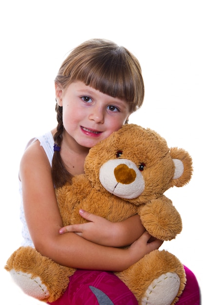 girl hugging a teddy bear