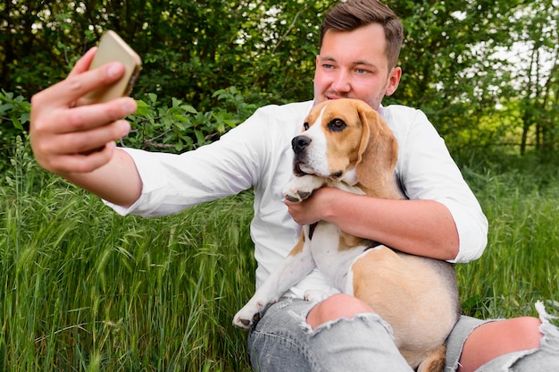 彼の犬と一緒にselfieを取る大人の男性 無料の写真