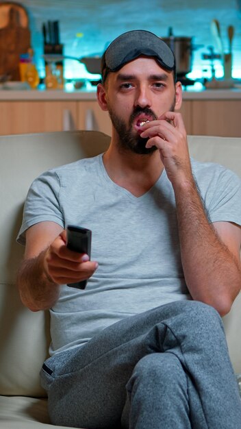 Premium Photo Adult Man Eating Popcorn While Standing In Front Of