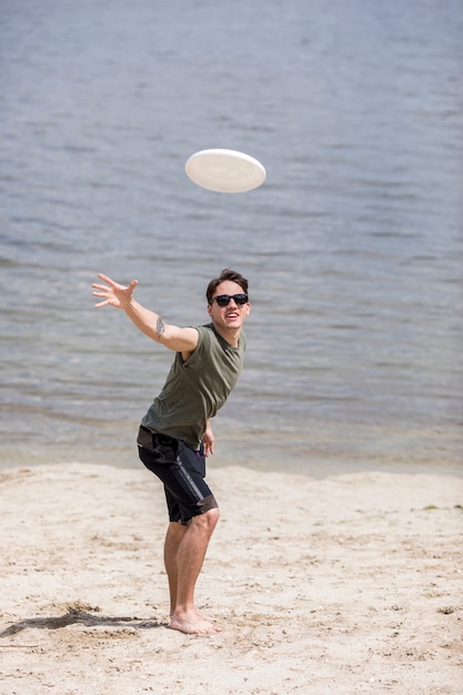 Free Photo Adult Man Throwing Frisbee Disc On Beach 3408