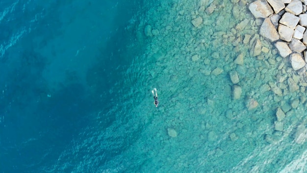 Aerial One Person Diver Swimming Fishing In Crystal Clear