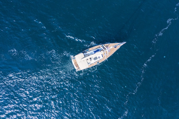 Premium Photo | Aerial view of a beautiful white sailing yacht with a ...