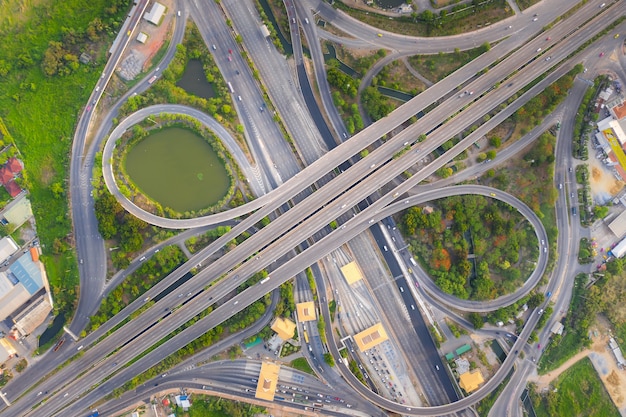 Aerial view above of busy highway road junctions at day. the intersecting freeway road overpass. Premium Photo
