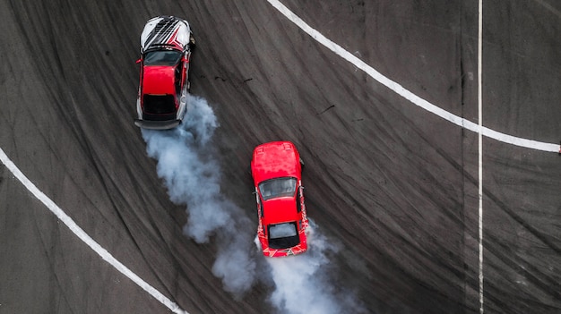 Premium Photo | Aerial view drift battle, two cars drift battle on race ...