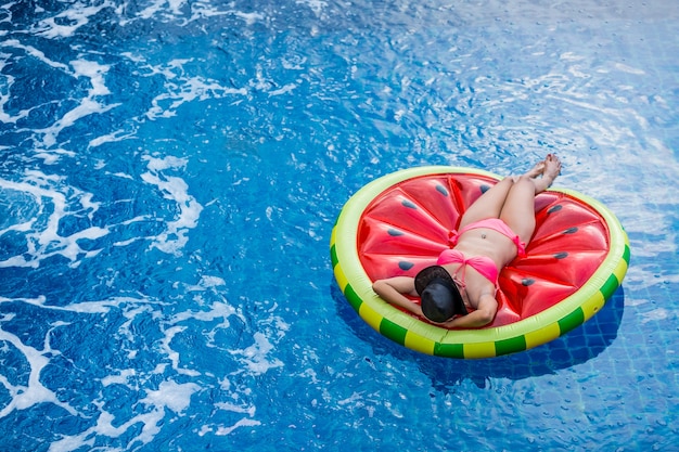Premium Photo Aerial View Of Female In Bikini Lying On A Floating Mattress In Swimming Pool
