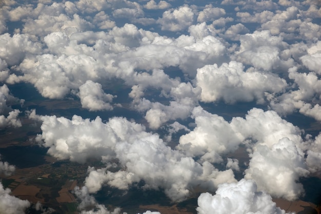Premium Photo | Aerial view from airplane window of white puffy clouds ...
