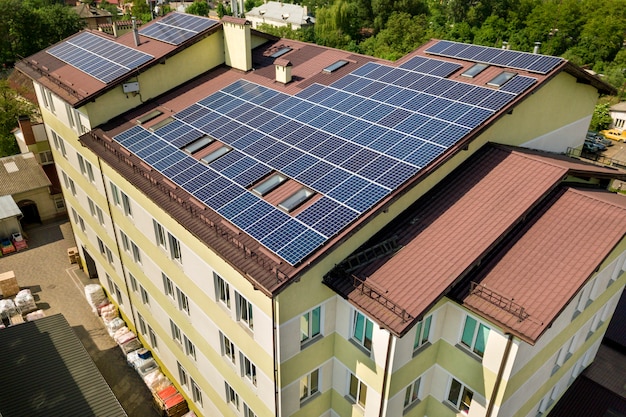 Aerial view of many solar panels on building roof. Premium Photo