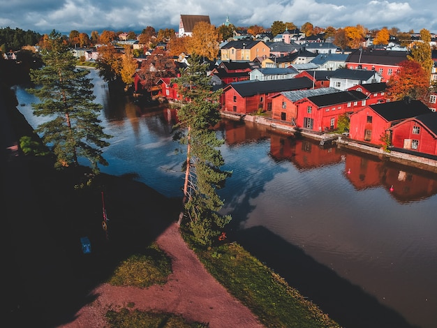 Aerial View Of The Old Red House And Barns By The River Premium