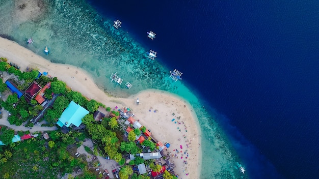 Free Photo | Aerial view of sandy beach with tourists swimming in ...