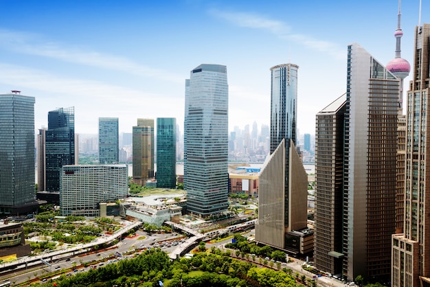 Aerial view of shanghai's high density central business area. high rise office buildings and skyscrapers with glass surface. urban roads with multiple lanes and green city park. shanghai, china Premium Photo