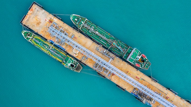 Aerial view tanker ship unloading at port, business import export oil with tanker ship. Premium Photo