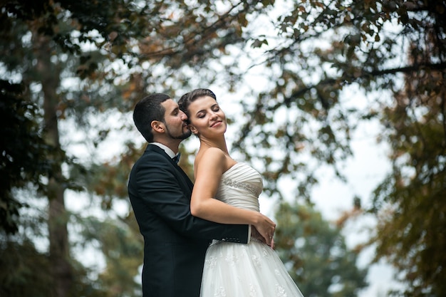 affectionate-groom-embracing-his-wife-photo-free-download