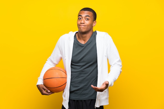 African american basketball player man making doubts gesture while lifting the shoulders Premium Photo
