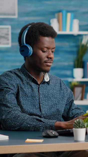 Premium Photo | African american black manager using headphones to ...