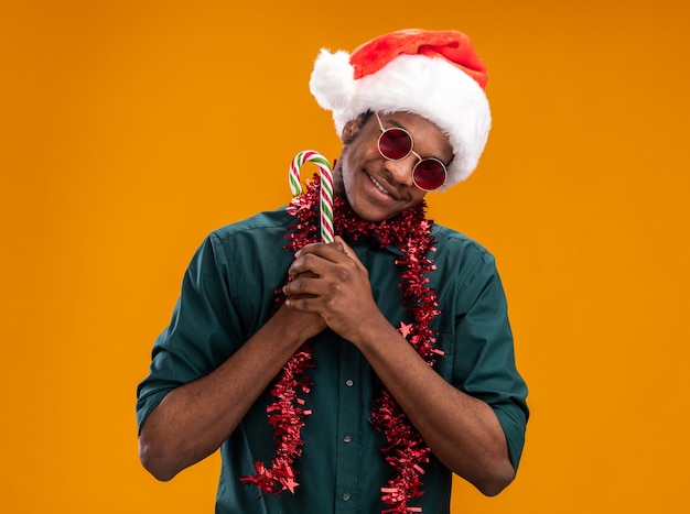 Free Photo | African american man in santa hat with garland wearing ...