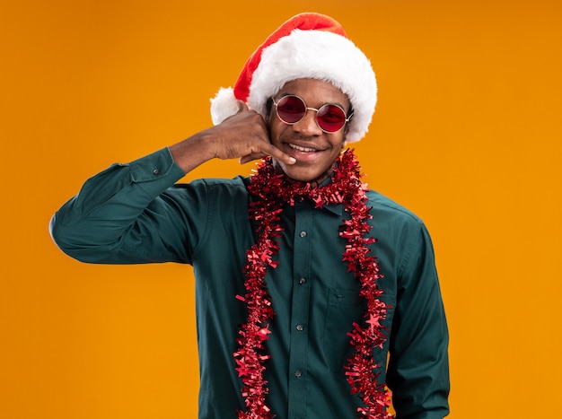 Free Photo | African american man in santa hat with garland wearing ...