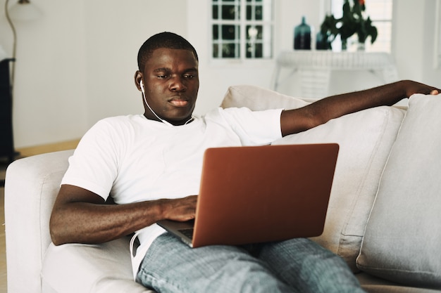 Premium Photo | African american man working at home freelancer laptop
