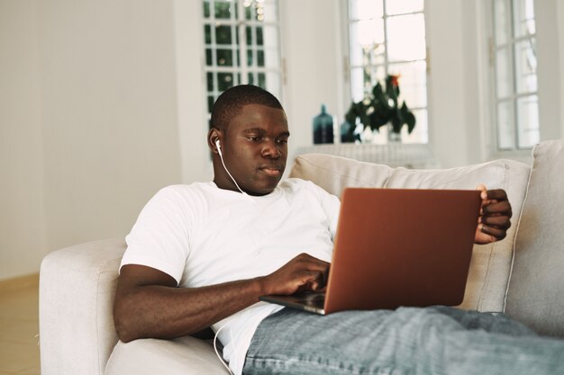 Premium Photo | African american man working at home freelancer laptop