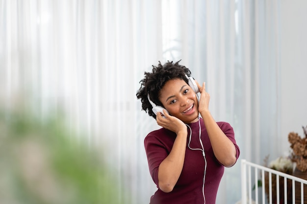 Premium Photo | African american woman listening music with her ...