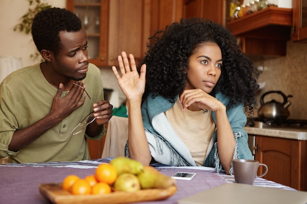 African Couple Having Quarrel At Home Unhappy Husband Apologizing For