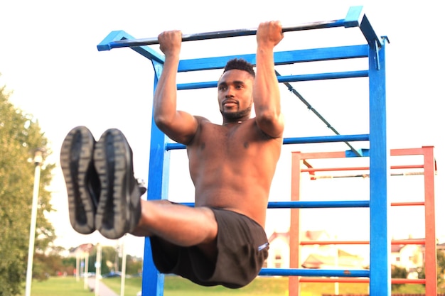 Premium Photo | African man doing street workout on the beach, at ...