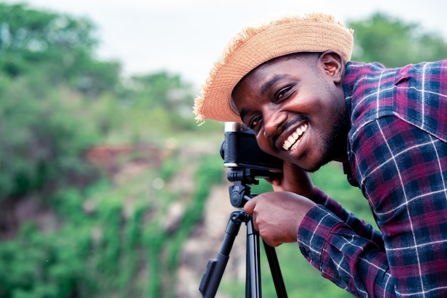 Premium Photo | African man photograpy taking the camera and tripod ...