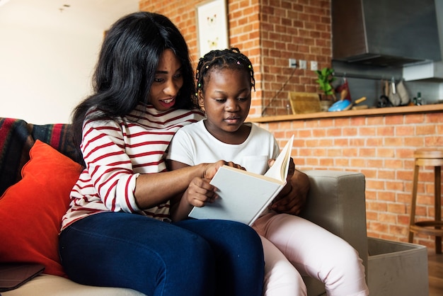 Premium Photo | African mother helping her daughter in doing her homework