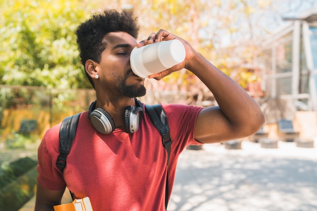 Free Photo | Afro university student drinking a cup of coffee.