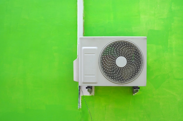 Premium Photo | Air conditioning compressor near the green wall texture ...