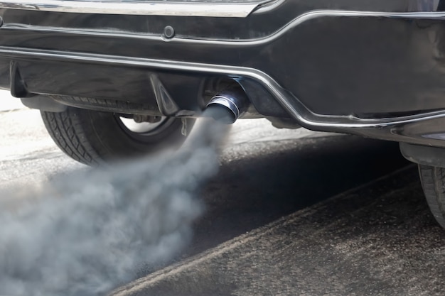Premium Photo | Air pollution from vehicle exhaust pipe on road