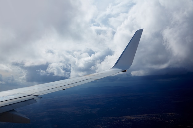 Premium Photo Aircraft Wing In A Cloudy Stormy Clouds Sky