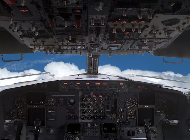 Premium Photo | Airplane is flying above white clouds on blue sky on ...